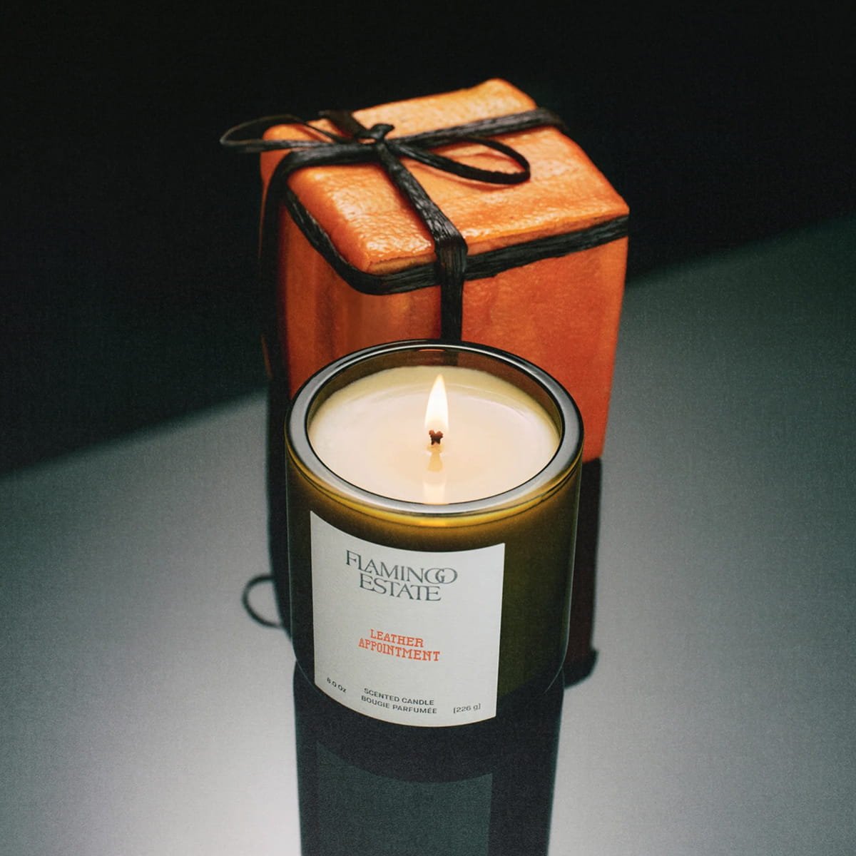 Flamingo Estate Leather Appointment (226 g) - product shown in front of leather box.