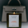 Flamingo Estate Leather Appointment (226 g) - product shown in front of leather bag.
