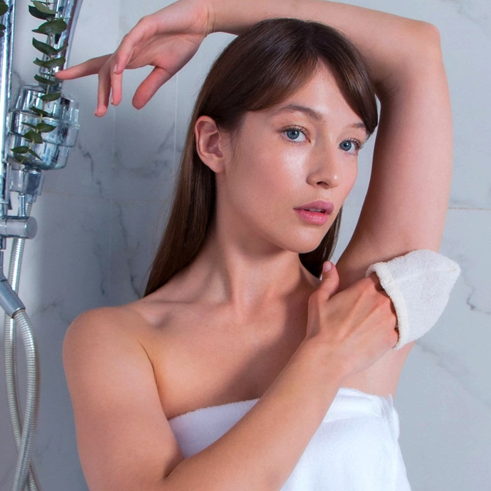 Woman in shower using Daily Concepts Daily Grooming Hammam Mitt on underarm