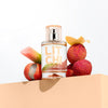 Lifestyle shot of Solinotes Litchi Eau de Parfum (50 ml) with Litchi in the background