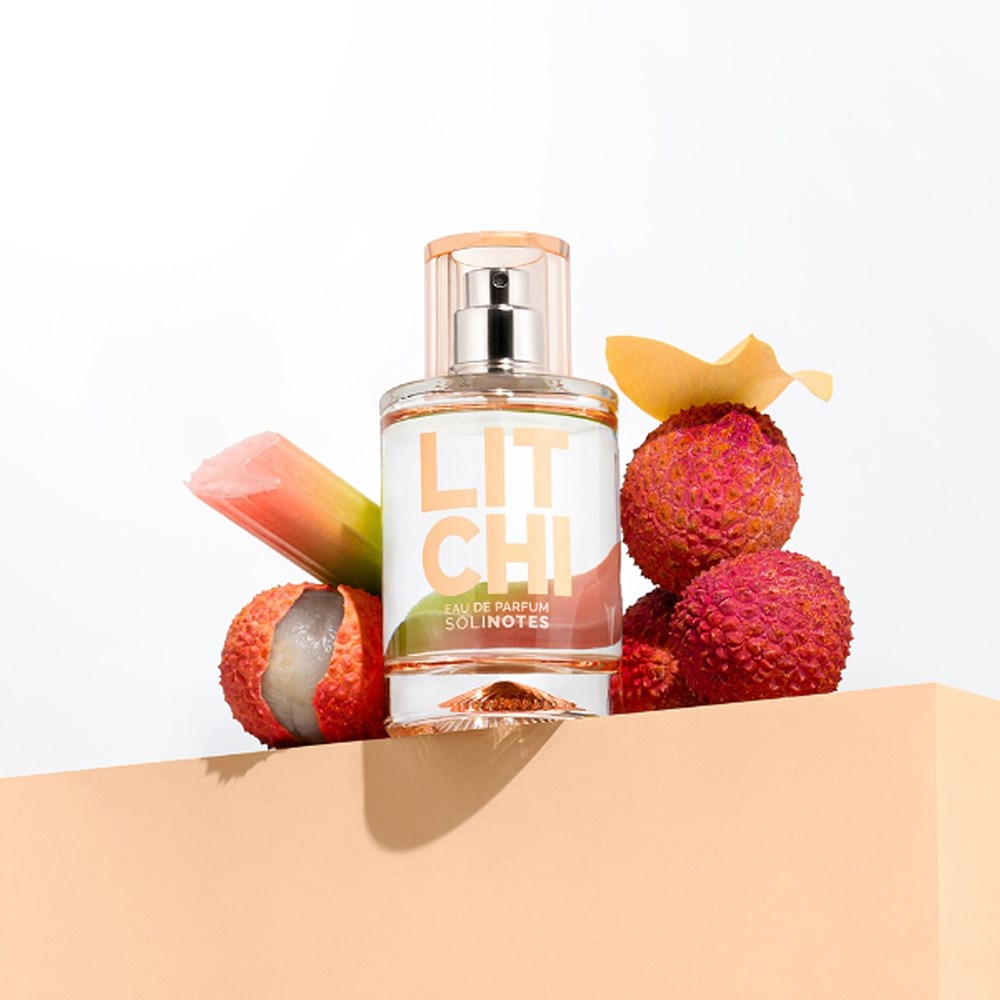 Lifestyle shot of Solinotes Litchi Eau de Parfum (50 ml) with Litchi in the background