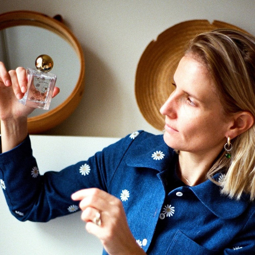 Minois Paris X Flolove Eau de Toilette (50 ml) - product shown being held by woman. 