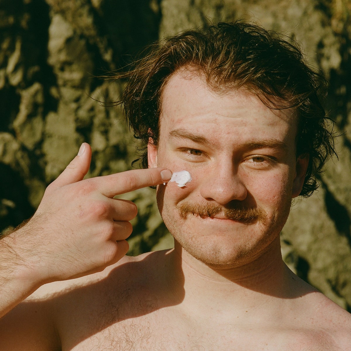 Dr. Max’s Diaper Ointment (3.3 oz) - product shown being applied on models face. 