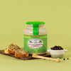 Pommery Green Peppercorn Mustard (250 g) - product shown on cutting board with ingredients and wooden spoon. 