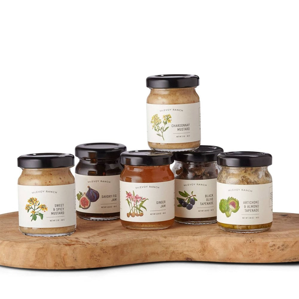 McEvoy Ranch Charcuterie Gift Set (6 pcs) - products shown on wooden cutting board.