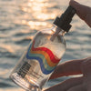 Bathing Culture Golden Hour Hydrosol - Neroli & Rose - model shown holding product near water