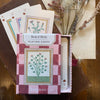 Roomytown Inc Book of Herbs Playing Cards (1 set) - product shown on wooden table. 