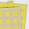 Close up of Wrap Squares Oat/Yellow Cotton Tea Towel (1 pc) showing front and back