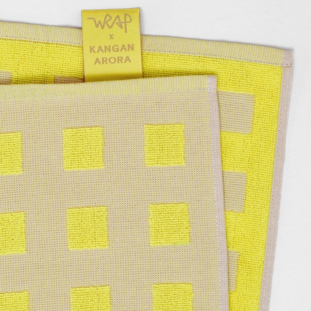 Close up of Wrap Squares Oat/Yellow Cotton Tea Towel (1 pc) showing front and back
