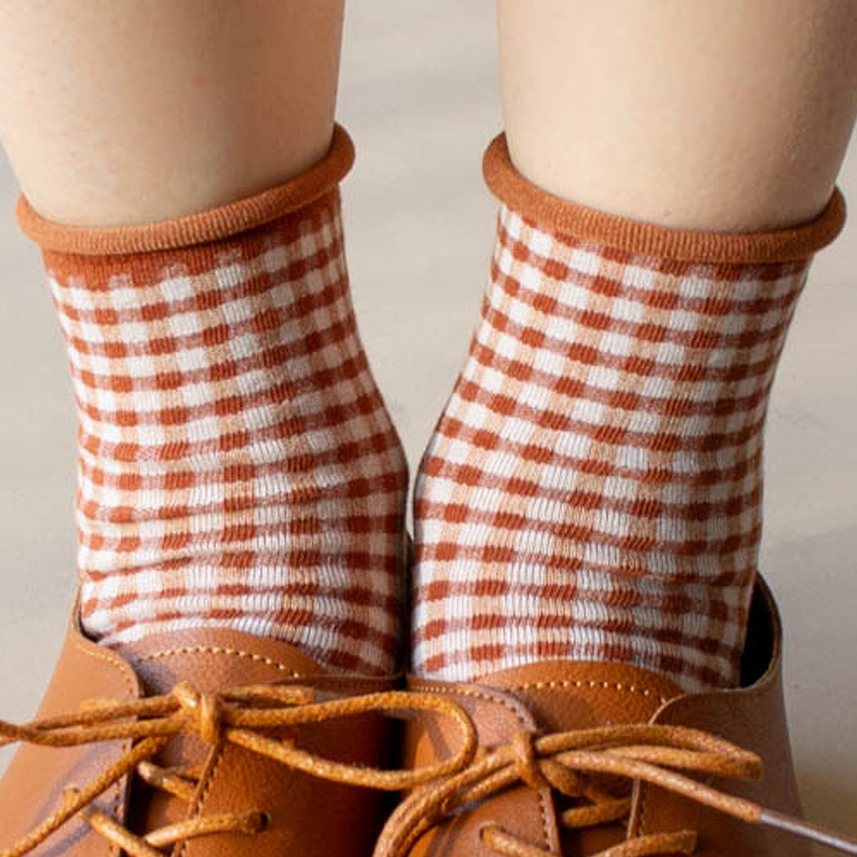 Close up of model shown wearing Tiepology Picnic Mid Crew Socks - Rust 