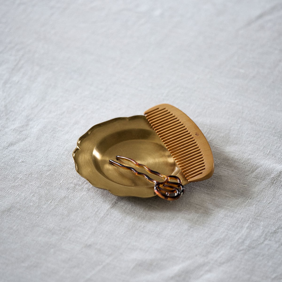 Fog Linen Work Brass Decorative Plate - Small (1 pc) - product shown with a comb and hair accessory. 