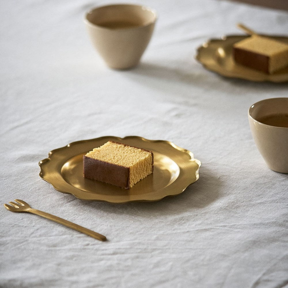 Fog Linen Work Brass Decorative Plate - Medium (1 pc) - product shown on table with piece of cake. 
