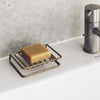 Fog Linen Work Brass Soap Stand (1 pc) - product shown on sink with soap bar on top. 