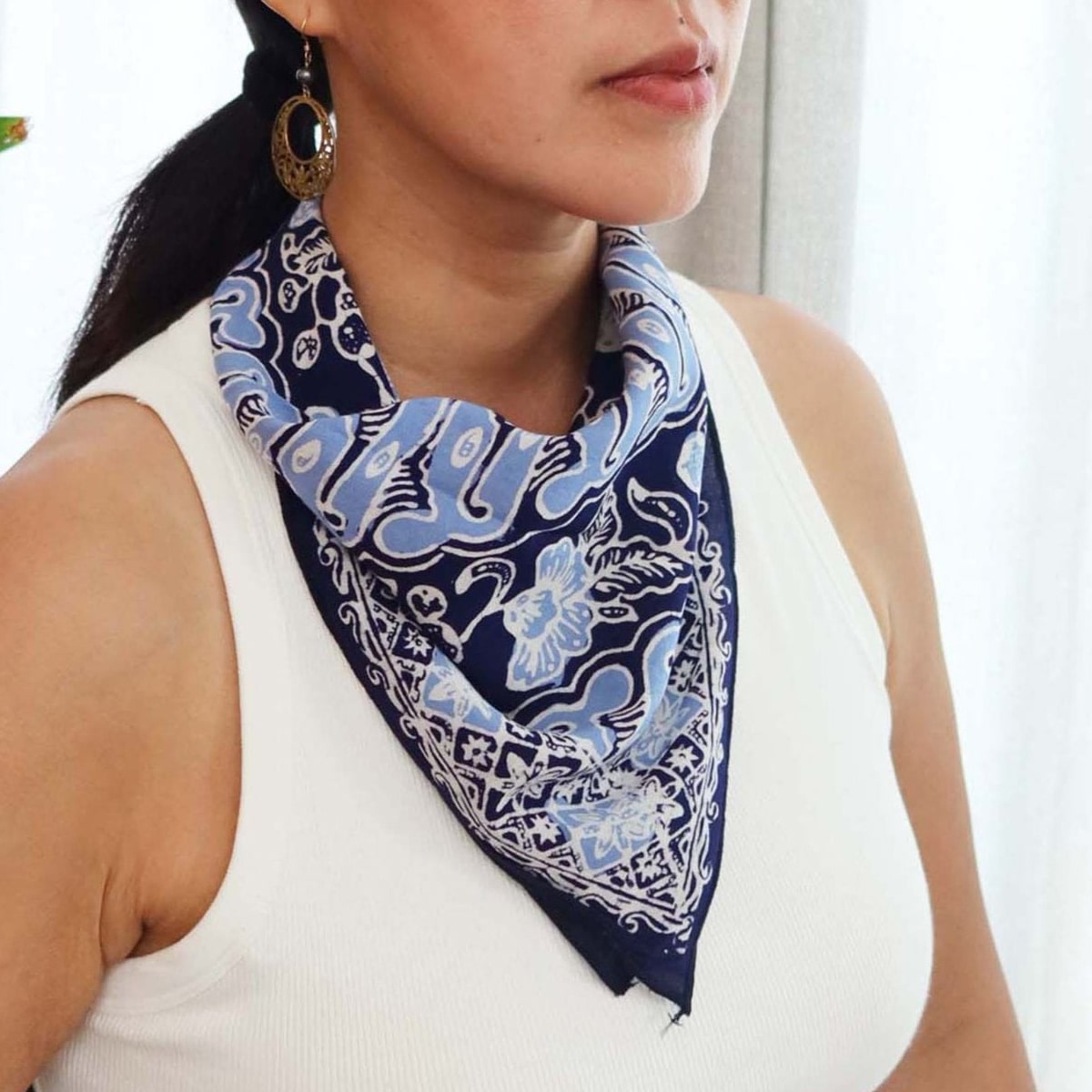 Kasih Co-op Hand Dyed Batik Bandana - Blue/White (1 pc) shown around neck of model