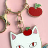 Centinelle Apple Cat Keychain Charm (1 pc) - product shown up close on pink background. 