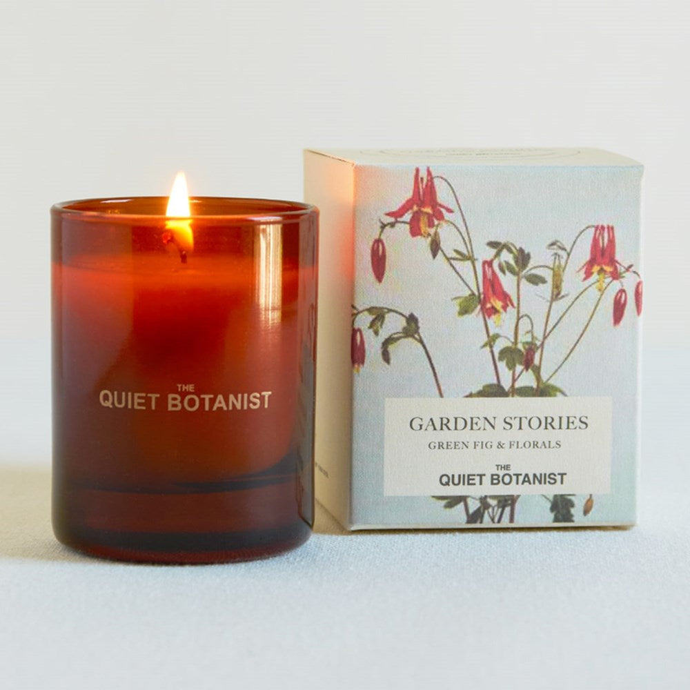 The Quiet Botanist Garden Stories Mini Candle (3 oz) - product shown next to its packaging. 