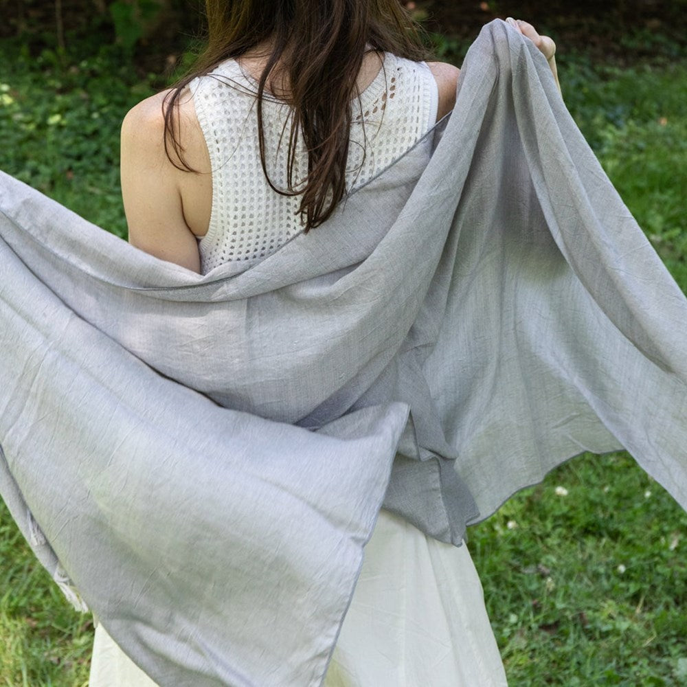 Kontex Haolu Cotton Wool Stole - Pewter (1 pc) - product shown being held by model on green grass. 