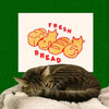 Pencil & Post Fresh Bread Riso Print (1 pc) - product shown on green background with cat in front of it.
