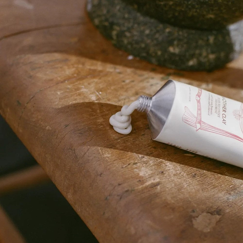 St. Meto Mother Clay Hair Recovery Treatment (4 oz)  - product shown coming out of tube. 