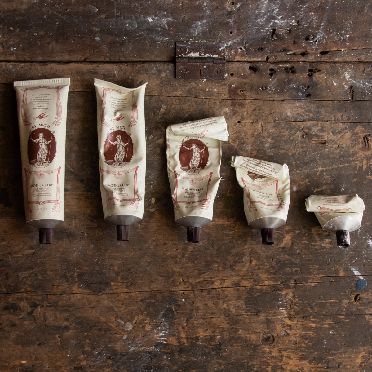 St. Meto Mother Clay Hair Recovery Treatment (4 oz)  - product shown on wood. 