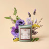 Rifle Paper Co. Country Farm Champs De France Glass Candle (9.5 oz) with flowers in the background