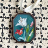 Maris Mirum Small Locket - Tulip Trio (1 pc) shown on patterned black and white paper