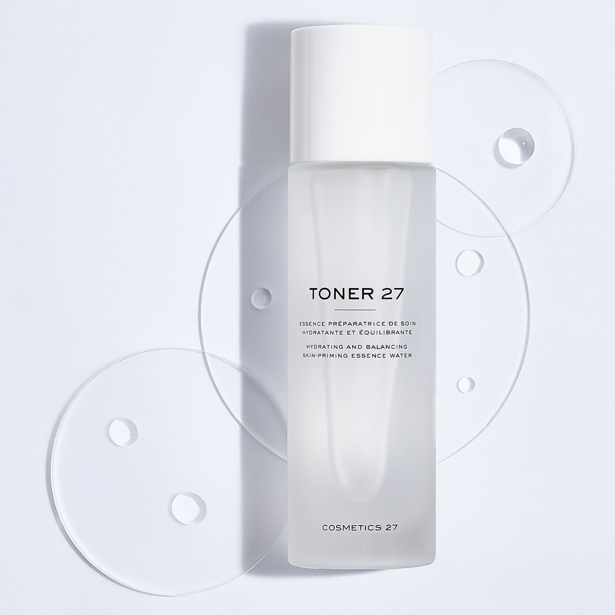 Cosmetics 27 Toner 27 Hydrating and Balancing Skin-Priming Essence Water (100 ml) with product drops in the background