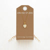 Amano Studio Small Heart Enamel Locket Necklace - Beige (1 pc) - product shown in packaging. 