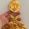 Foot Range Mountain Embossed Gold Moon and Moth (1 pc) - product shown being held. 