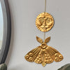 Foot Range Mountain Embossed Gold Moon and Moth (1 pc) - product shown hung on wall. 