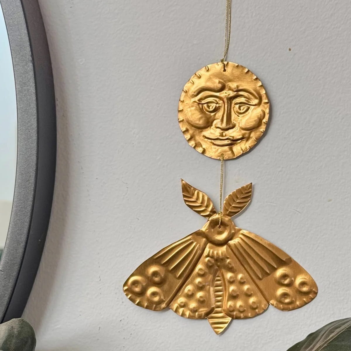 Foot Range Mountain Embossed Gold Moon and Moth (1 pc) - product shown hung on wall. 