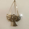 Foot Range Mountain Embossed Tin Bird (1 pc) - product shown hanging on white wall. 