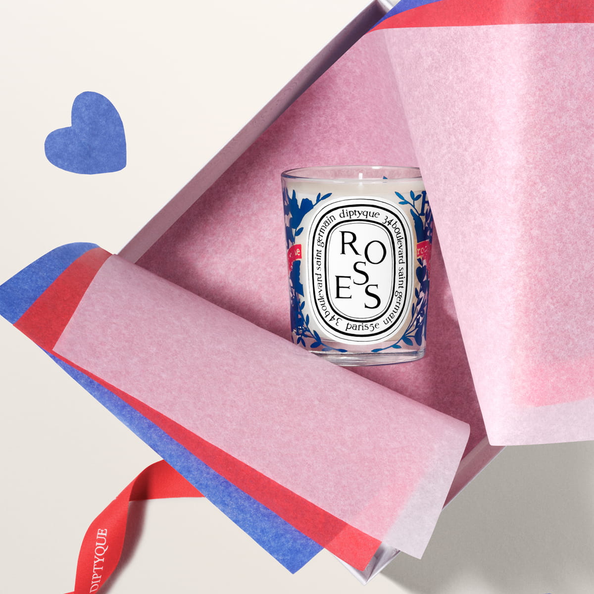Diptyque Limited Edition Roses Candle (190 g) inside a gift box with tissue paper and purple heart in the background