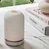 NEOM Organics Wellbeing Pod (1 pc) - product shown on marble counter with books. 