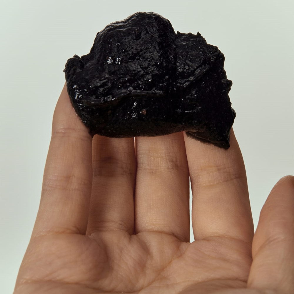 House of Balance 4:00PM Black Bean Pod Body Scrub (180 ml) - product shown on hand. 