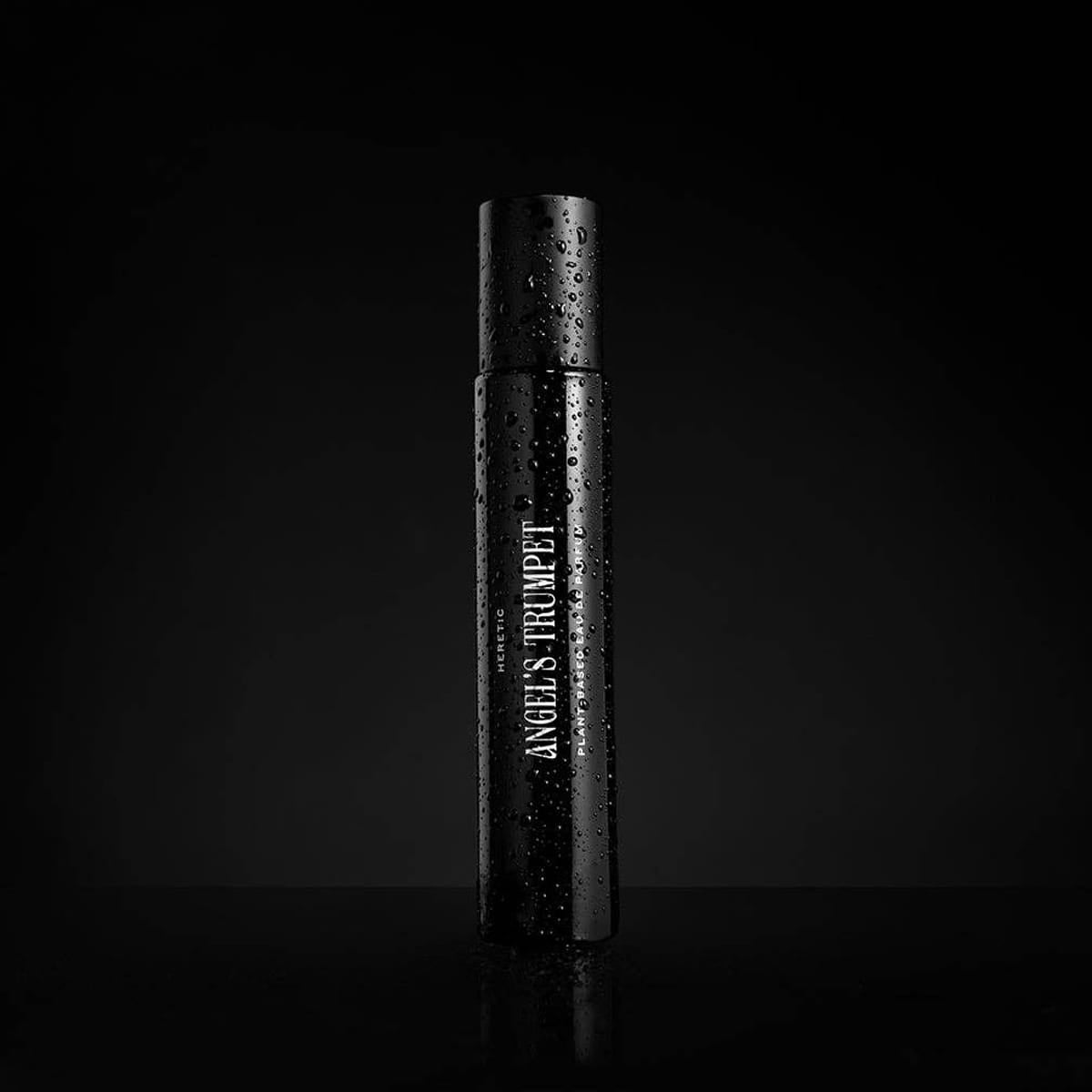 Heretic Parfum Angels Trumpet Eau de Parfum (15 ml)  - product shown on black background wet. 