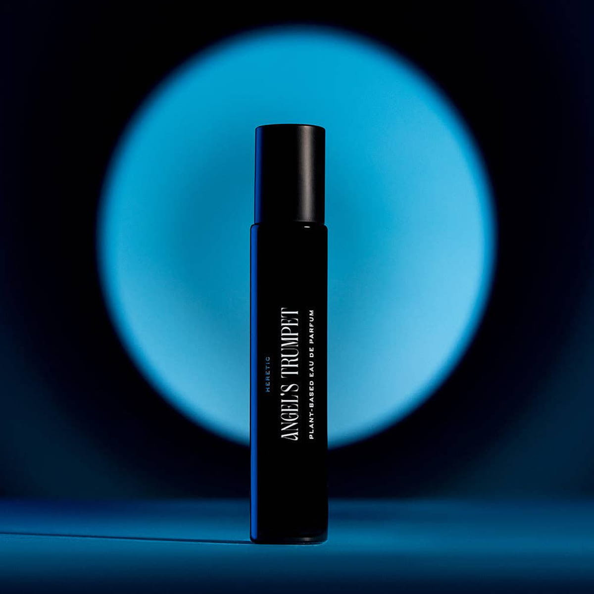 Heretic Parfum Angels Trumpet Eau de Parfum (15 ml)  - product shown in front of blue circle of light.