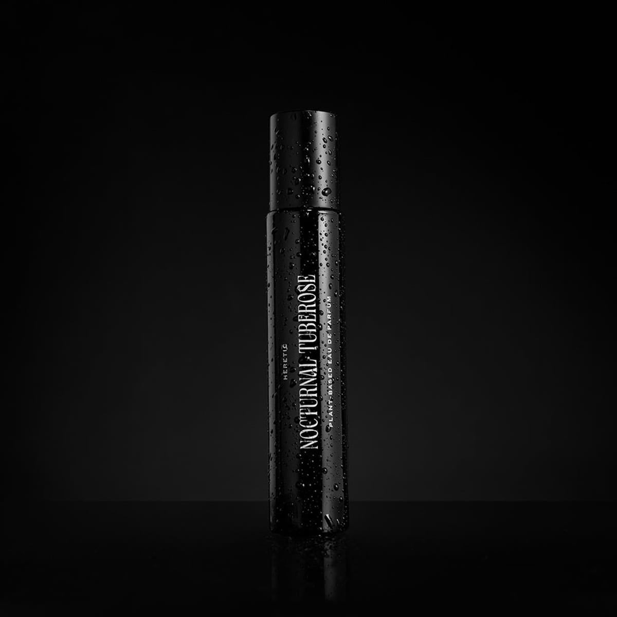 Heretic Parfum Nocturnal Tuberose Eau de Parfum (15 ml) - product shown on black background wet. 