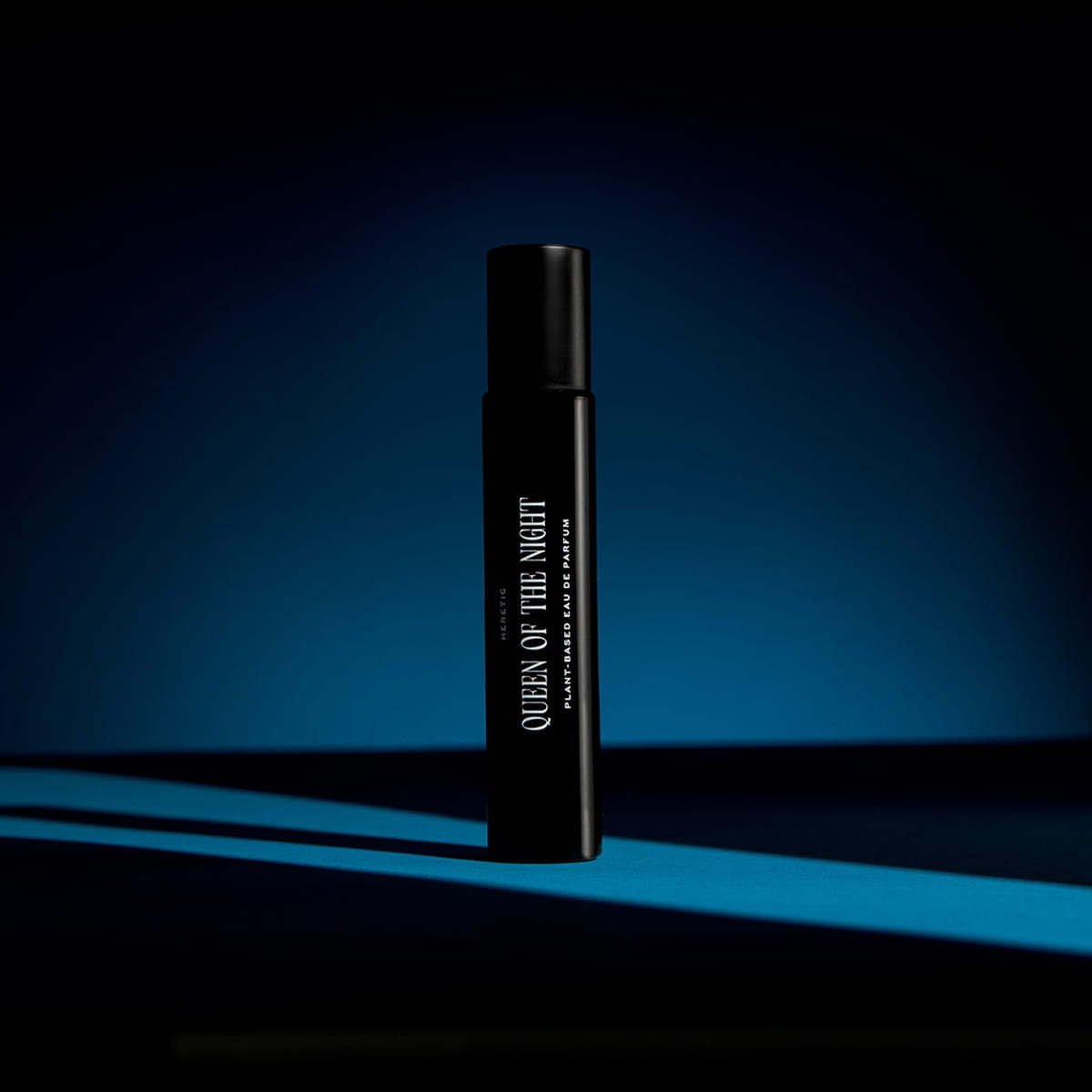 Heretic Parfum Queen of the Night Eau de Parfum (15 ml) - product shown on dark background with blue light. 