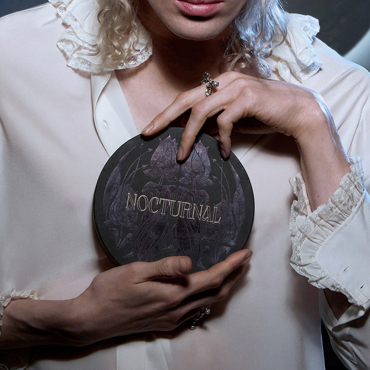 Heretic Parfum Nocturnal Discovery Set (3 pcs) - product shown being held by model in white blouse. 