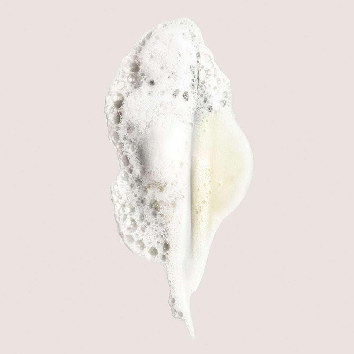 Oribe Eternal Curls Moisturizing Shampoo (8.5 oz) - product shown on beige background as swatch.