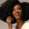 Oribe Eternal Curls Cleansing Creme (8.5 oz) - model shown on grey background.