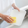 Kamenoko Tawashi Sponge - Yellow (1 pc) - product shown being used to wash white plate. 