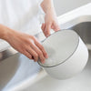 Kamenoko Tawashi Sponge - Grey (1 pc) - product shown being used to clean white pot. 