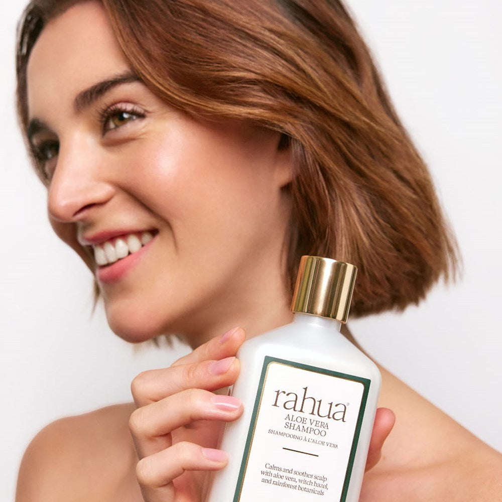 Rahua Aloe Vera Shampoo (275 ml) - product shown being held by model. 