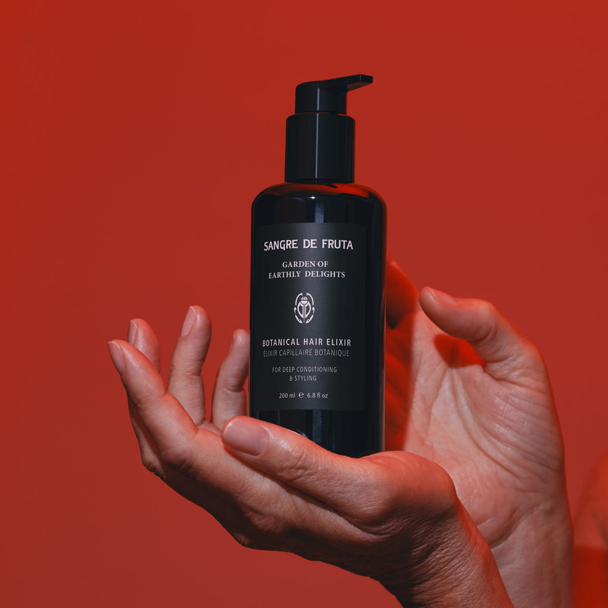 Sangre de Fruta Botanical Hair Elixir - Garden of Earthly Delights (200 ml) - product shown being held.