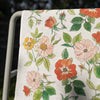 Botanica Paper Co. Wild Roses Tea Towel (1 pc) - product shown outside draped over metal pole. 
