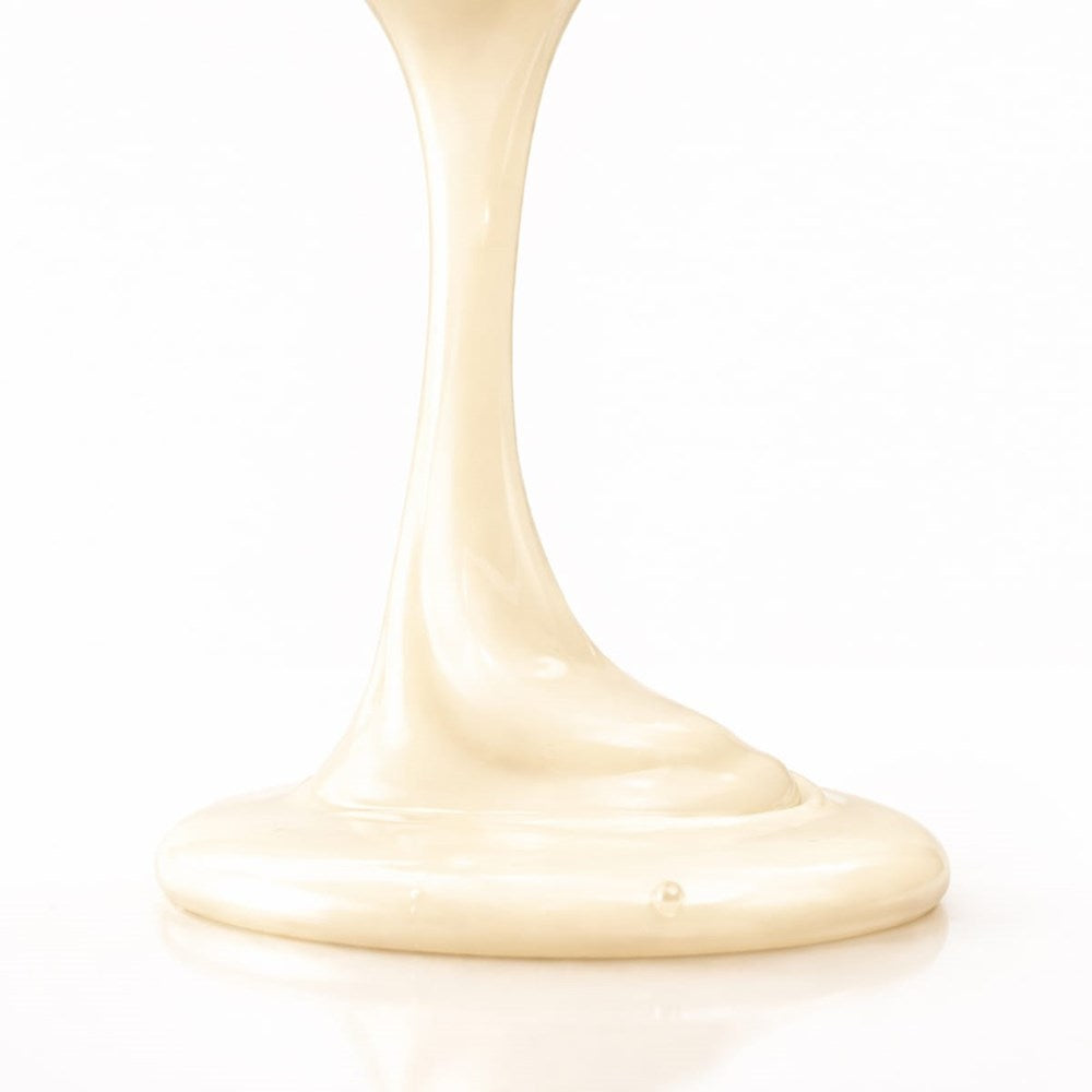 Leonor Greyl Bain Sublime Couleur (200 ml) - product shown being poured onto white counter. 