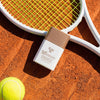 Yon-Ka Paris 50+ Mineral Fluid Broad Spectrum Sunscreen (30 ml) - product shown on orange dirt with tennis racket and ball.