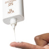 Yon-Ka Paris 50+ Mineral Fluid Broad Spectrum Sunscreen (60 ml) - product shown being poured out of the bottle.